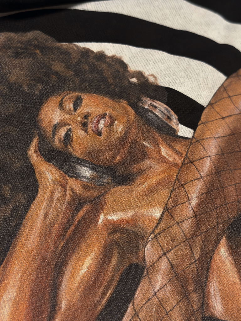 Close-up of the Mixed Pleasure artwork printed on faded black cotton